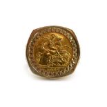 A 9ct yellow gold ring set half sovereign dated 1982 in a loose pierced George and the dragon mount,