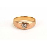 A yellow metal ring set old cut diamond in a recessed star setting, stone approximately 0.