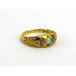 A late Victorian 18ct yellow gold ring set opal and six old cut diamonds in recessed settings,