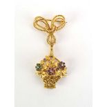 An 18ct yellow gold gem set pendant brooch suspending a canework basket set diamonds, emeralds,