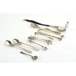 A mixed parcel of silver comprising three pairs of sugar tongs, a salt spoon, two teaspoons,