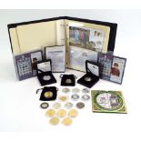 A group of coinage including an album containing three silver coin covers,