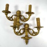 A pair of brass two-branch wall lights,