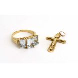 A 9ct yellow gold dress ring set three pale blue stones, ring size Q,