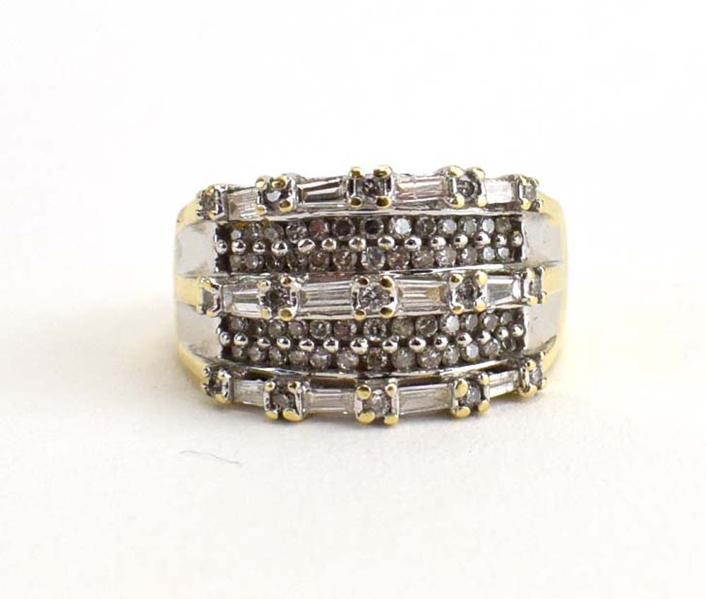 A 14ct yellow gold dress ring set small brilliant and baguette cut diamonds, ring size O, 6.