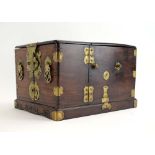 A Korean brass bound vanity box, the interior with a mirror and various drawers, on a plinth base,