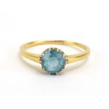 A yellow metal ring set pale blue coloured stone in a ten claw setting, ring size T, 3.