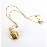 A 9ct yellow gold fine flat curblink necklace suspending a heart shaped pendant locket, overall 6.