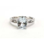 A modern 14ct white gold ring set oval aquamarine in a four claw setting,