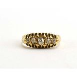 An Edwardian 18ct yellow gold ring set five graduated old cut diamonds in an openwork setting,