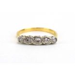 An 18ct yellow gold ring set five graduated diamonds in illusion settings, ring size O, 2.