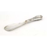 An Edwardian silver shoe horn, the handle repousse decorated in the Rococo manner, Mappin & Webb,