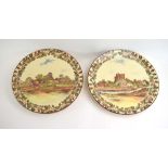 A Royal Doulton charger decorated with a view of a castle within an acorn border, d.