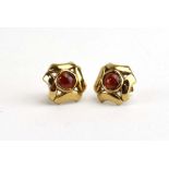 A pair of 9ct yellow gold ear studs, each set cabochon garnet within an openwork setting, w. 1.