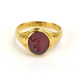 An 18ct yellow gold signet ring set hardstone, Birmingham 1924, ring size N 1/2, 3.