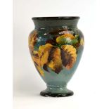 A late 19th century Doulton Lambeth Impasto ware vase of ovoid form painted with autumnal leaves of