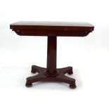 A 19th century mahogany card table, the folding surface on a tapering column,