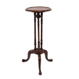 A 19th century wine table, the circular top on three supports, platform base and three splayed legs,