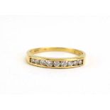 A yellow metal half eternity ring set nine brilliant cut diamonds in a channel setting, ring size N,