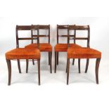 A set of four 19th century mahogany bar back dining chairs with upholstered seats and sabre legs