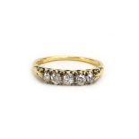 An early 20th century 18ct yellow gold ring set five graduated old cut diamonds in raised settings,