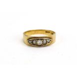 An early 20th century 15ct yellow gold ring set three graduated old cut diamonds interspersed with