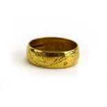 An 18ct yellow gold wedding florally engraved band, band w. 6 mm, London 1967, ring size P, 5.