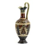A late 19th century Doulton Lambeth ewer with incised foliate decoration within jeweled borders on