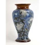 A Royal Doulton stoneware vase of baluster form relief decorated with white carnations on a mottled