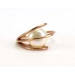 A modern 9ct rose gold ring set cultured pearl in an openwork setting, ring size L, 2.