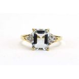 A 9ct yellow gold ring set rectangular cut aquamarine in a four claw setting,