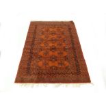 A mid-to-late 20th century Turkomen rug, the red ground with repeated motifs within matching bands,