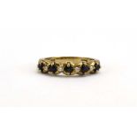 A 9ct yellow gold half eternity ring set five dark sapphires and four small diamonds, ring size L,