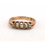 An early 20th century yellow metal ring set five graduated old cut diamonds, ring size O 1/2, 2.