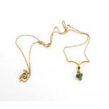 An 18ct yellow gold fine chainlink necklace suspending an emerald set pendant drop,
