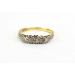 An early 20th century 18ct yellow gold ring set three small diamonds in illusion settings,