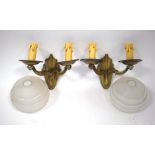 A pair of Art Deco brass twin-branch wall lights together with two ribbed glass shades