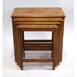 A nest of four quartetto walnut and brass inlaid nesting tables on square supports, max. w.