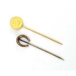 A yellow metal stick pin set a coronation half farthing dated 1902, l. 7.