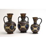 A graduated pair of Doulton Lambeth stoneware jugs,