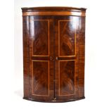 A Georgian mahogany, walnut and crossbanded bow-fronted corner cabinet,