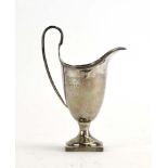 A silver helmet shaped cream jug on a square plinth foot, CJV Ltd., London 1977, h.