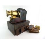 A late 19th/early 20th century magic lantern together with three winding slides,