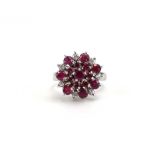An 18ct white gold cluster ring set diamonds and rubies, ring size M, 4.