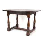 An 18th-century type oak refectorary table with a carved frieze,