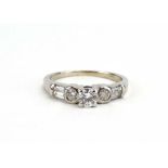 A modern 18ct white gold ring set brilliant cut diamond in a four claw setting,