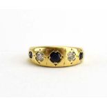 An 18ct yellow gold ring set three graduated sapphires interspersed with two small diamonds in