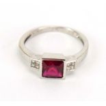 A 9ct white gold ring set square cut red coloured stone in a stepped setting,