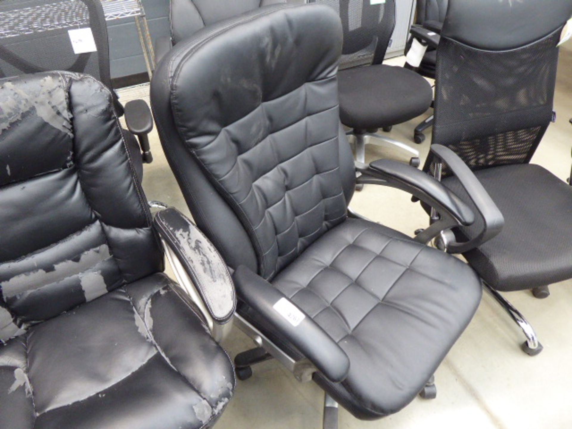 High backed office swivel armchair in black on grey supports