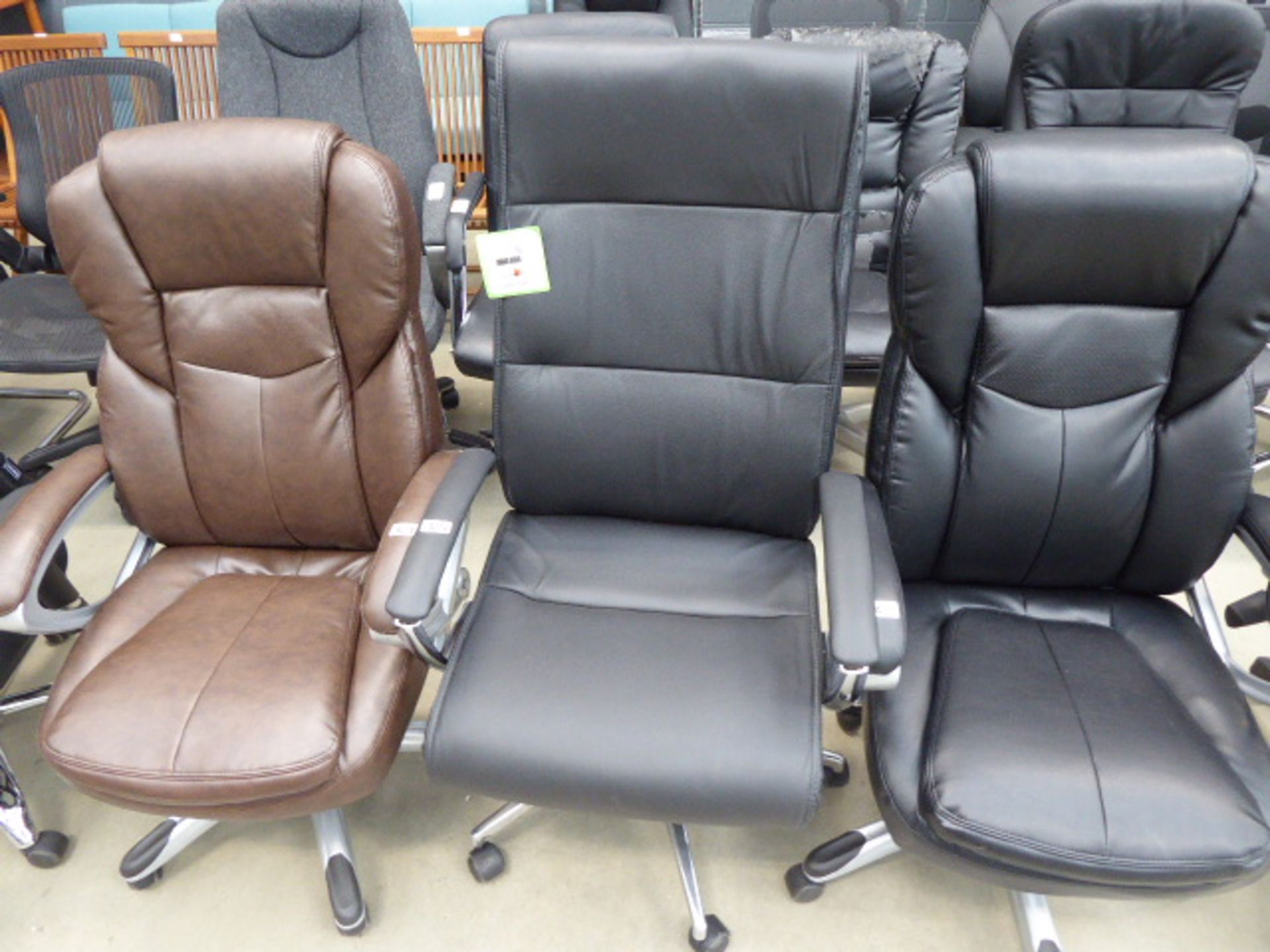 High backed office swivel armchair in brown on chrome supports